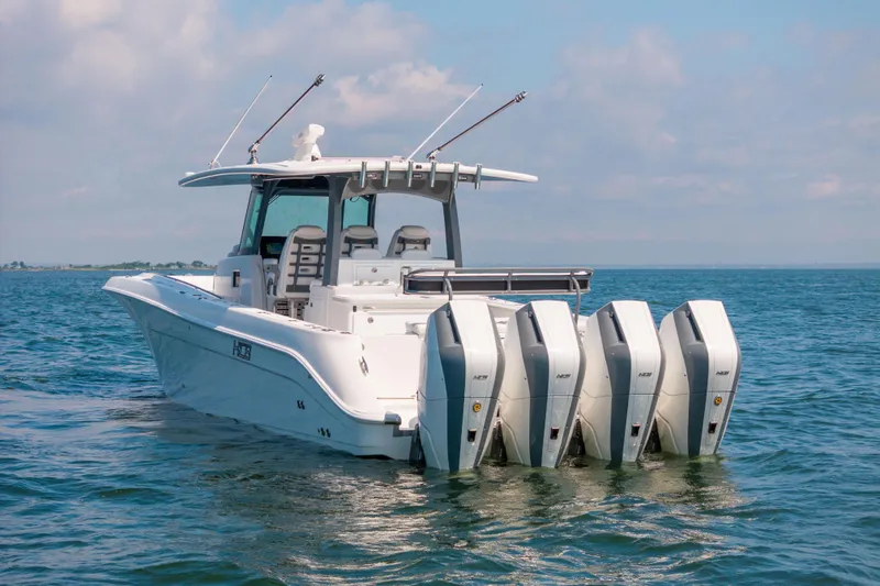 Slide: The Image of 2026 HCB 42 Lujo boat with four powerful outboard engines on open water. - 9