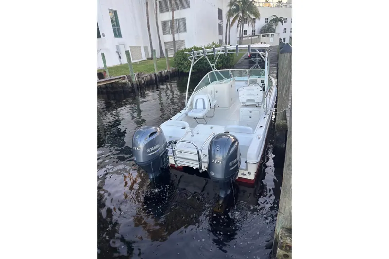 Slide: The Image of 2016 Carolina Cat 230 DC boat docked with dual Yamaha 115 engines. - 1