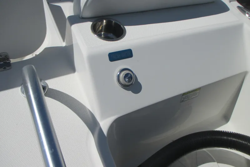 Slide: The Image of 2016 Carolina Cat 230 DC boat interior with fresh water access and cup holder. - 11