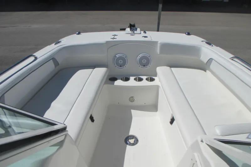Slide: The Image of 2016 Carolina Cat 230 DC boat interior with white seating and cup holders. - 14
