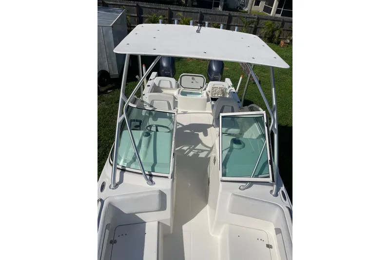 Slide: The Image of 2016 Carolina Cat 230 DC boat with open deck and dual consoles. - 19