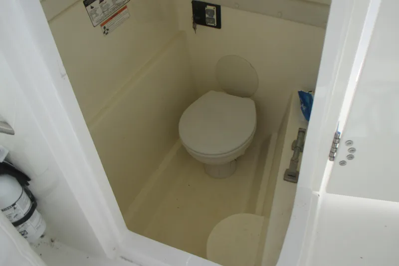 Slide: The Image of 2016 Carolina Cat 230 DC boat interior with compact marine toilet. - 21