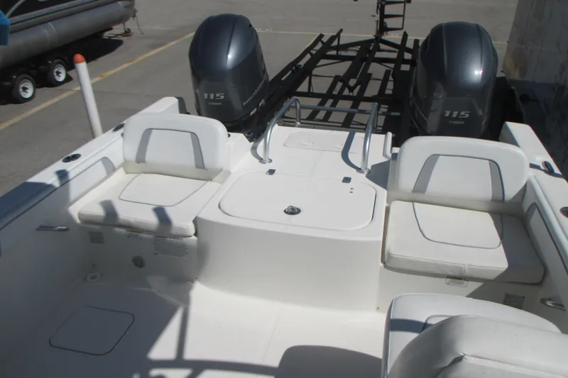 Slide: The Image of 2016 Carolina Cat 230 DC boat with dual Yamaha 115 engines, white seating, and spacious deck. - 7