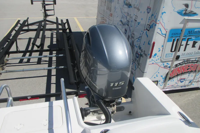 Slide: The Image of 2016 Carolina Cat 230 DC with Yamaha 115 outboard motor and trailer in parking lot. - 8