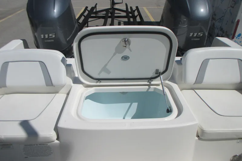 Slide: The Image of 2016 Carolina Cat 230 DC boat with open storage compartment and twin Yamaha 115 engines. - 9