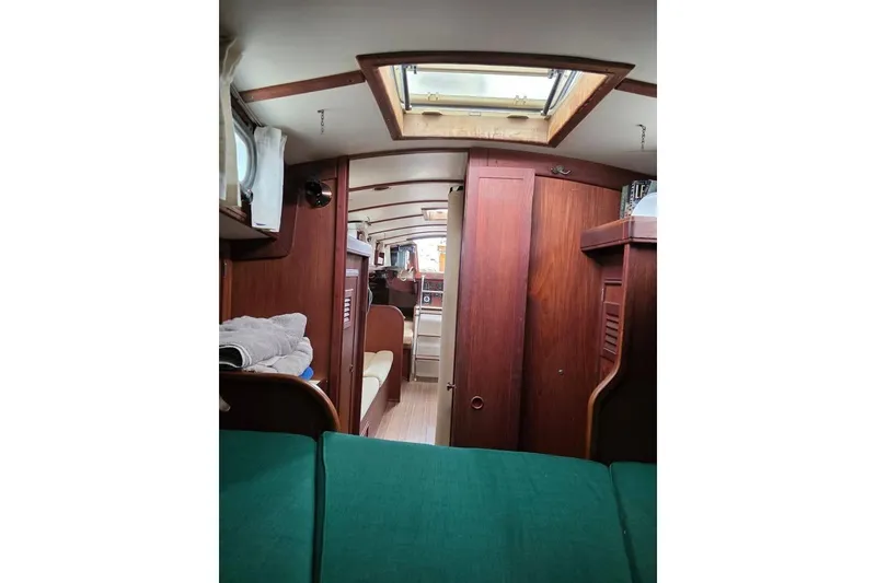 Slide: The Image of Interior of 1981 Cape Dory 36 sailboat, featuring wooden cabinetry and cozy seating. - 3