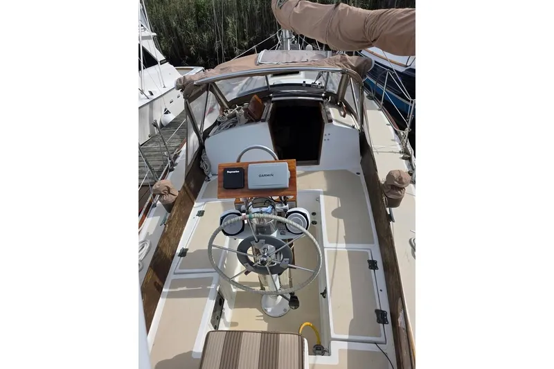 Slide: The Image of 1981 Cape Dory 36 sailboat cockpit with steering wheel and navigation equipment. - 4