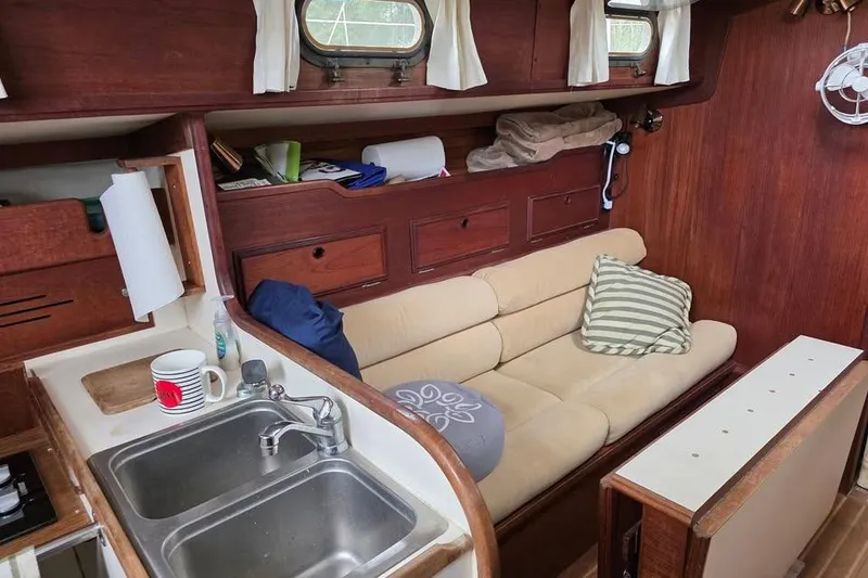 Slide: The Image of Interior of 1981 Cape Dory 36 sailboat with cozy seating and kitchenette. - 6