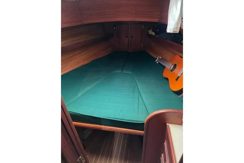 Slide: The Image of Cozy cabin interior of 1981 Cape Dory 36 sailboat with guitar on bed. - 9