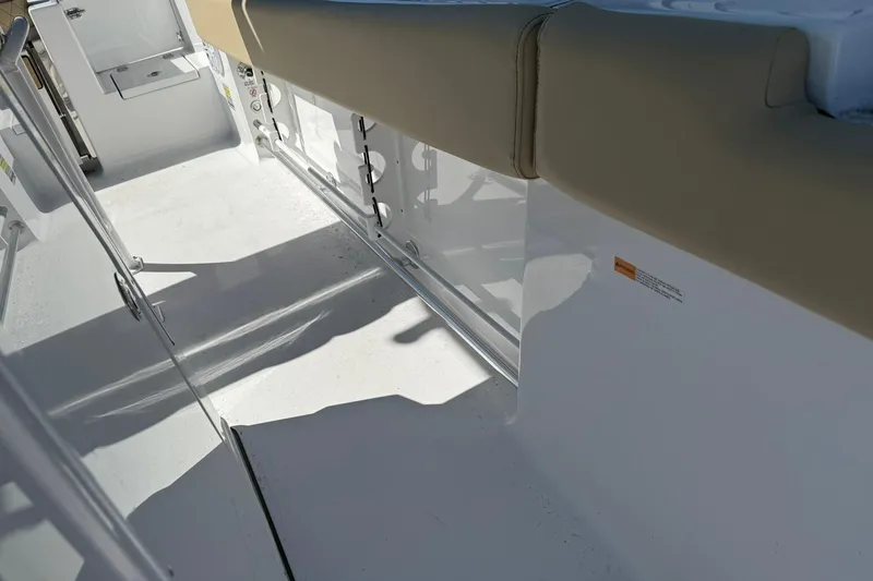 Slide: The Image of 2026 Sportsman Open 232 Center Console interior with beige seating and white deck. - 15