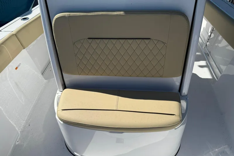 Slide: The Image of 2026 Sportsman Open 232 Center Console boat seat with beige upholstery and diamond stitching. - 16