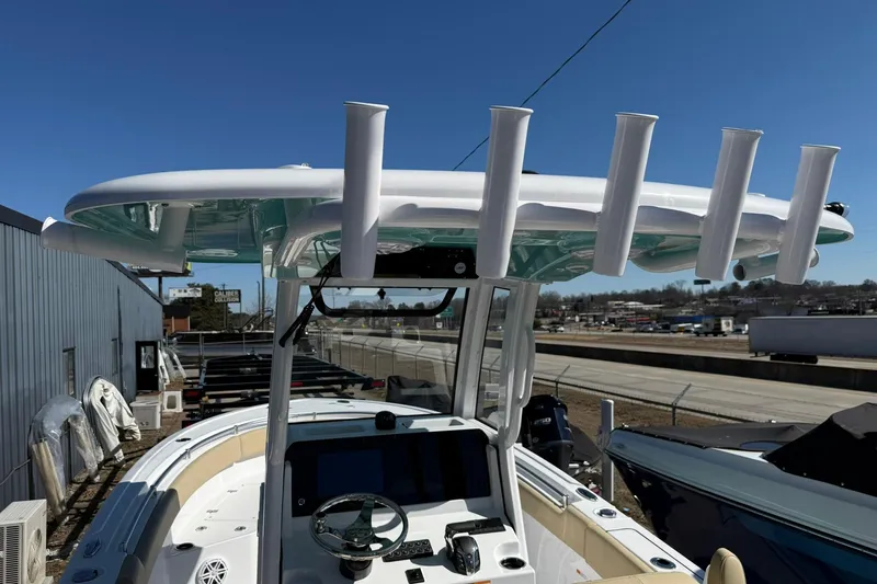 Slide: The Image of 2026 Sportsman Open 232 Center Console boat with rod holders and navigation equipment. - 18