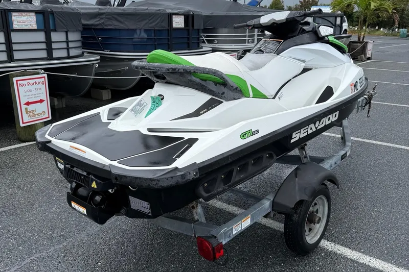 Slide: The Image of 2013 Sea-Doo GTI 130 jet ski on trailer in parking lot. - 8
