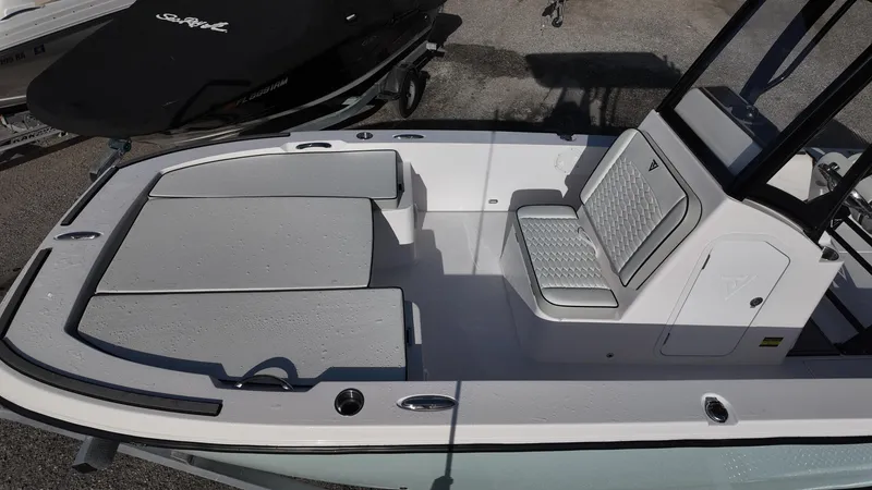 Slide: The Image of 2026 Twin Vee 22 Bay Cat boat interior with cushioned seating and sleek design. - 14