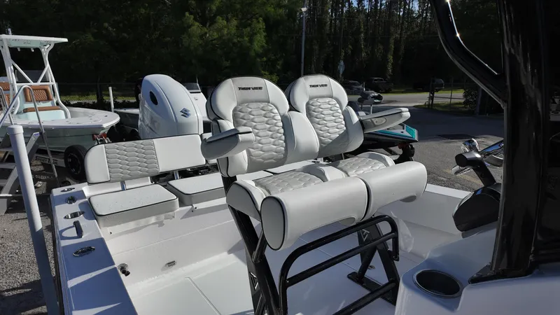 Slide: The Image of 2026 Twin Vee 22 Bay Cat boat interior with cushioned seating and modern design. - 17