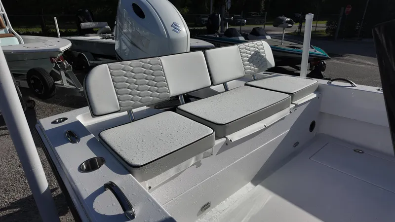 Slide: The Image of 2026 Twin Vee 22 Bay Cat boat interior with cushioned seating and modern design. - 18