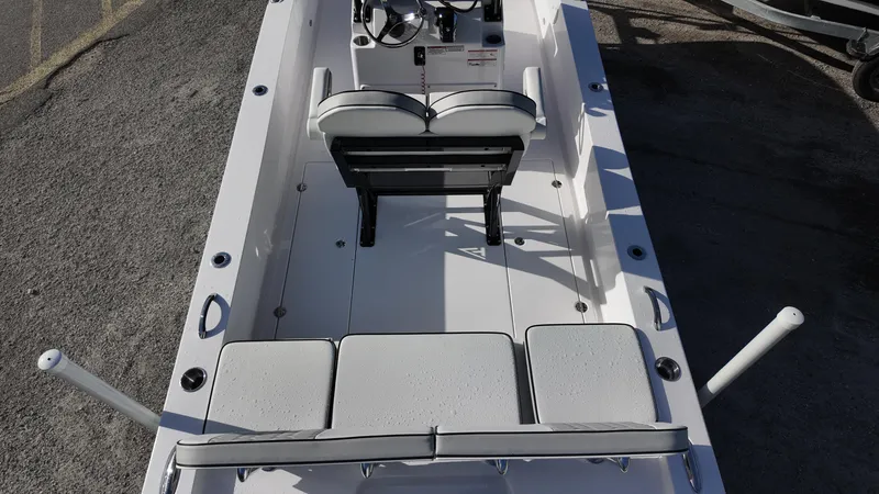 Slide: The Image of 2026 Twin Vee 22 Bay Cat boat interior with seating and steering console. - 19