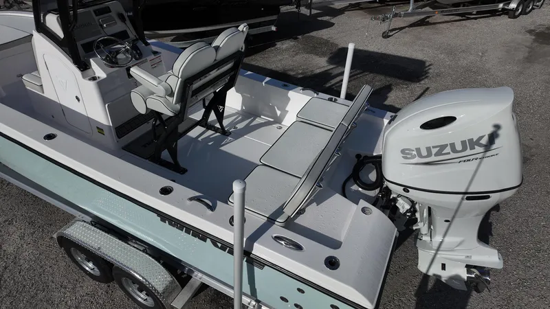 Slide: The Image of 2026 Twin Vee 22 Bay Cat boat with Suzuki outboard motor, parked on trailer. - 8