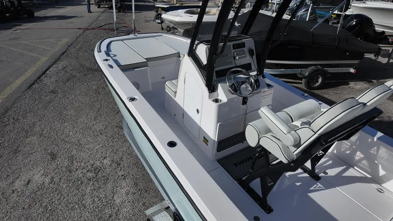 Slide: The Image of 2026 Twin Vee 22 Bay Cat boat interior with steering console and seating. - 9