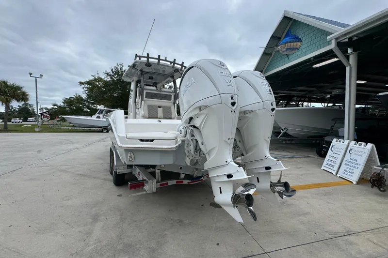 Slide: The Image of 2026 Solace 28 HCS boat with dual Yamaha engines at a marina. - 13
