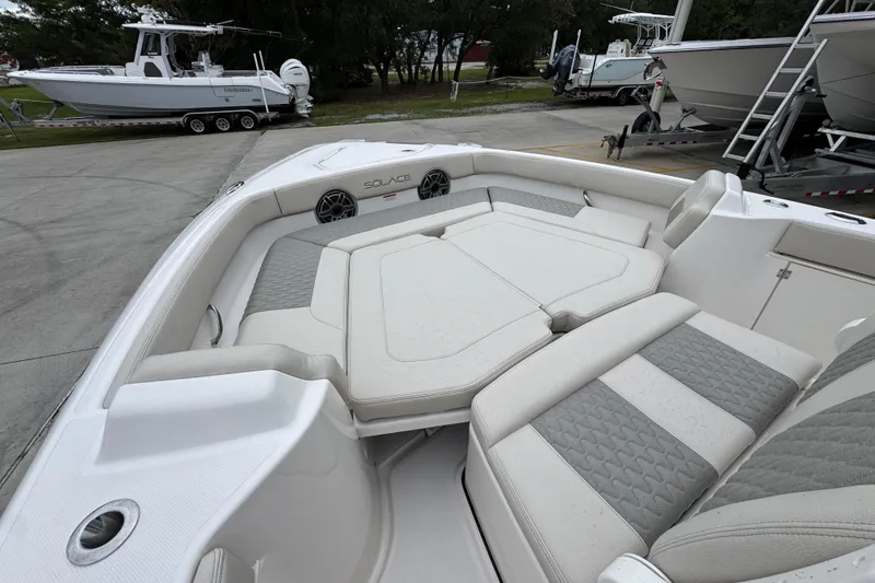 Slide: The Image of 2026 Solace 28 HCS boat interior with cushioned seating and sleek design. - 18