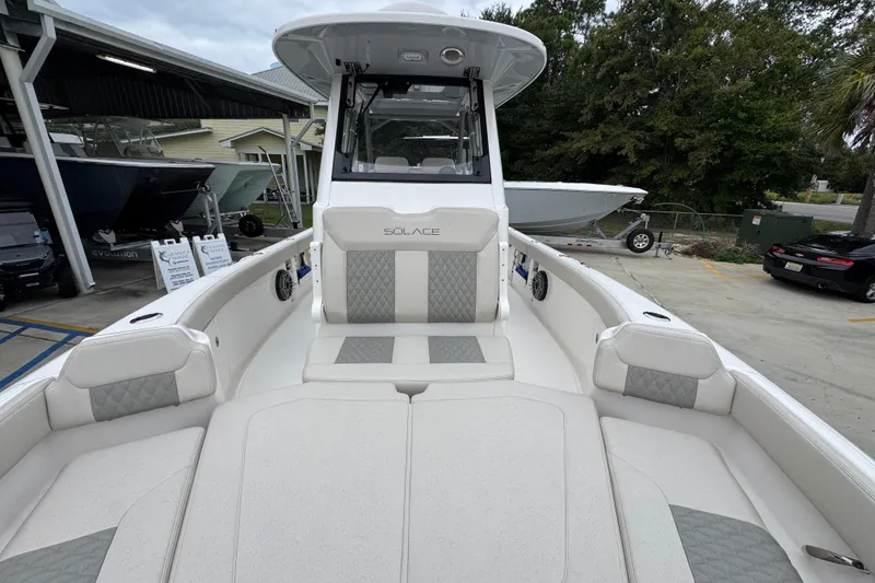 Slide: The Image of 2026 Solace 28 HCS boat with sleek design and comfortable seating in a marina setting. - 20