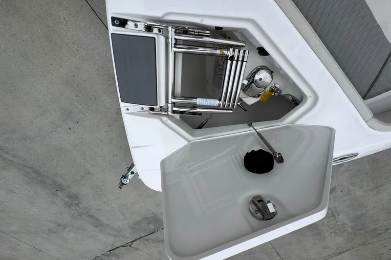 Slide: The Image of 2026 Solace 28 HCS boat deck with storage compartment and ladder. - 21