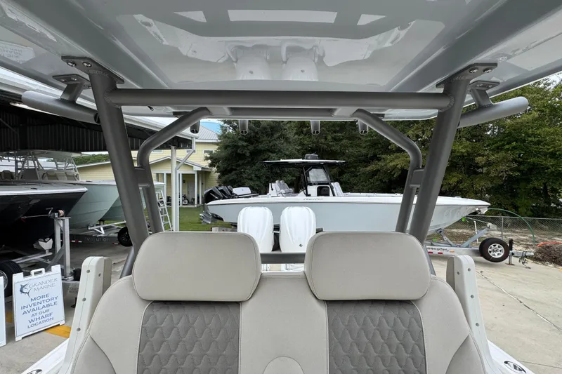 Slide: The Image of 2026 Solace 28 HCS boat interior with seating and view of another boat outside. - 29
