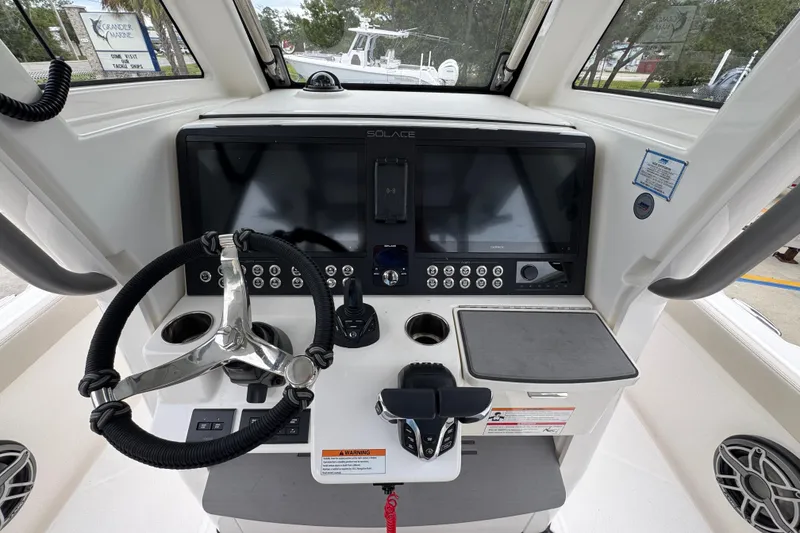 Slide: The Image of Helm of 2026 Solace 28 HCS boat with modern controls and navigation screens. - 31