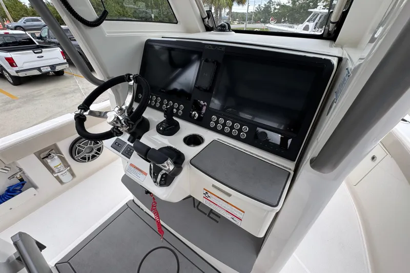 Slide: The Image of Helm of 2026 Solace 28 HCS boat with modern controls and steering wheel. - 33