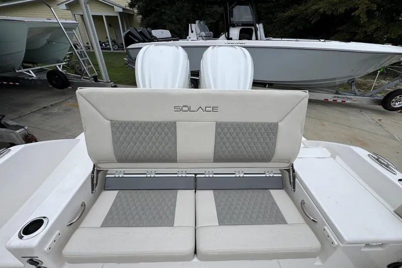Slide: The Image of 2026 Solace 28 HCS boat with cushioned seating and sleek design. - 39