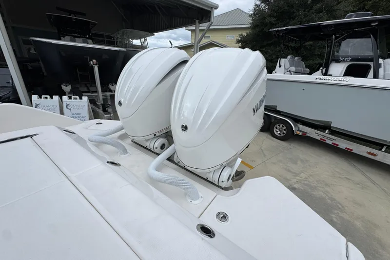 Slide: The Image of 2026 Solace 28 HCS boat with dual outboard engines in a marina setting. - 40