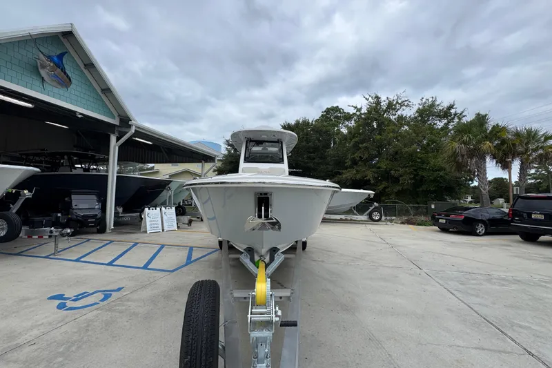 Slide: The Image of 2026 Solace 28 HCS boat on trailer at dealership, cloudy sky background. - 5