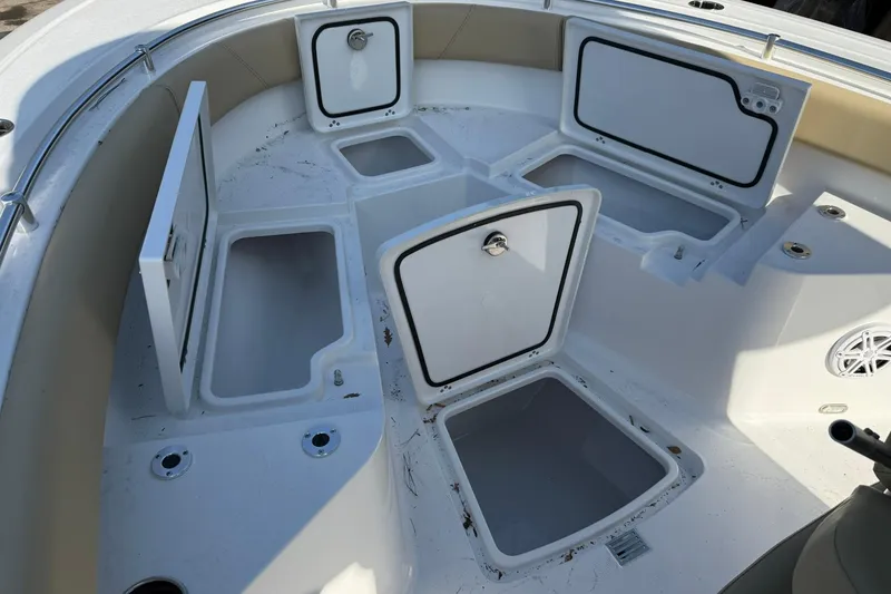 Slide: The Image of 2026 Sportsman Heritage 231 Center Console boat with open storage compartments. - 13