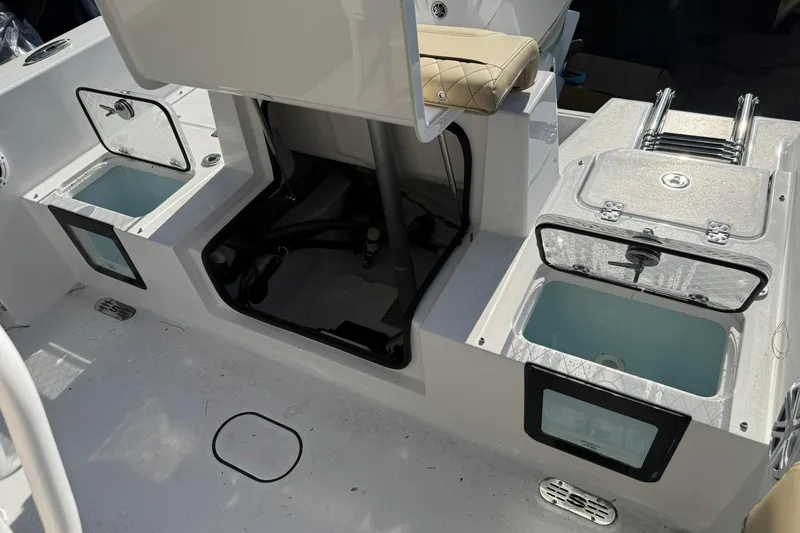Slide: The Image of 2026 Sportsman Heritage 231 Center Console boat interior with storage compartments and seating. - 15