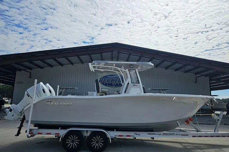 The Image of 2026 Sea Pro 262 Offshore boat on trailer at dealership under cloudy sky. - 1