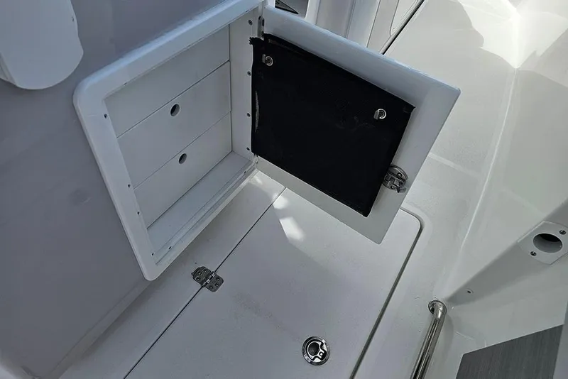 Slide: The Image of Open storage compartment on 2026 Sea Pro 262 Offshore boat deck. - 18