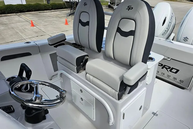 Slide: The Image of 2026 Sea Pro 262 Offshore boat interior with dual captain's chairs and steering wheel. - 24
