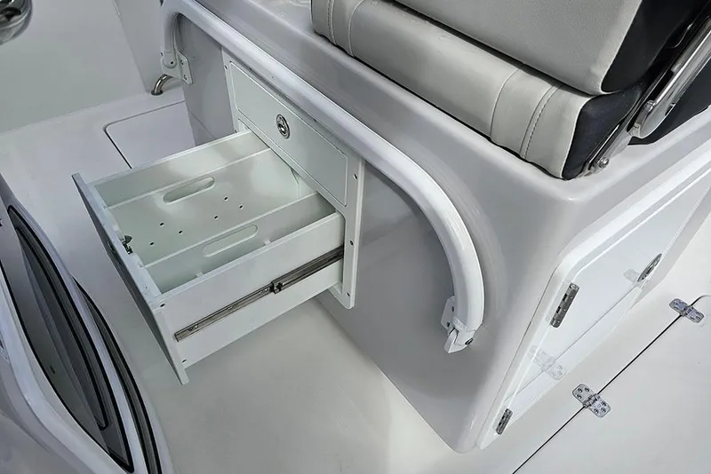 Slide: The Image of 2026 Sea Pro 262 Offshore boat interior with open storage drawer and cushioned seating. - 25