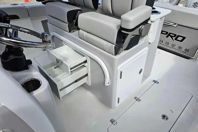 Slide: The Image of 2026 Sea Pro 262 Offshore boat interior with storage drawers and seating. - 26
