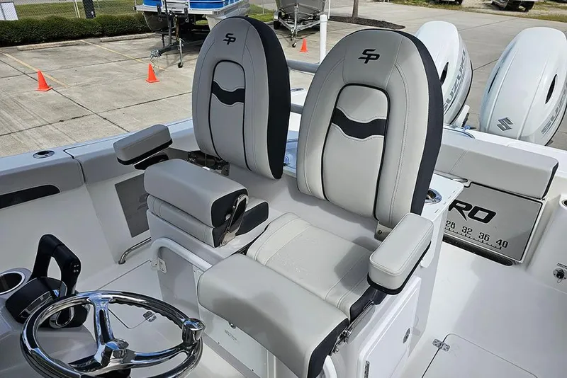 Slide: The Image of 2026 Sea Pro 262 Offshore boat interior with dual captain's chairs and steering wheel. - 27