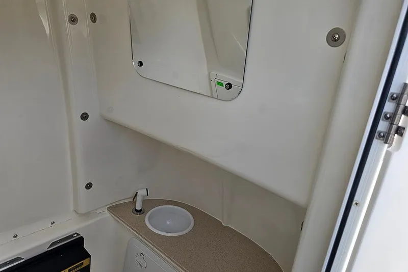Slide: The Image of Interior of 2026 Sea Pro 262 Offshore boat, featuring a compact sink and mirror. - 47