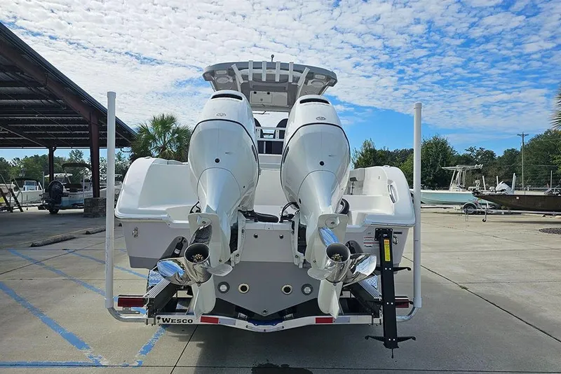 Slide: The Image of 2026 Sea Pro 262 Offshore boat with dual outboard engines, parked outdoors. - 9