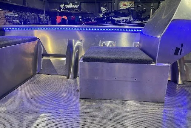 Slide: The Image of Interior of 2025 Blazer SS 17' boat with metal seating and blue LED lighting. - 11