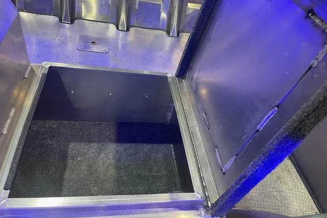 Slide: The Image of Open storage compartment in 2025 Blazer SS 17' vehicle, featuring metallic finish and carpeted interior. - 9