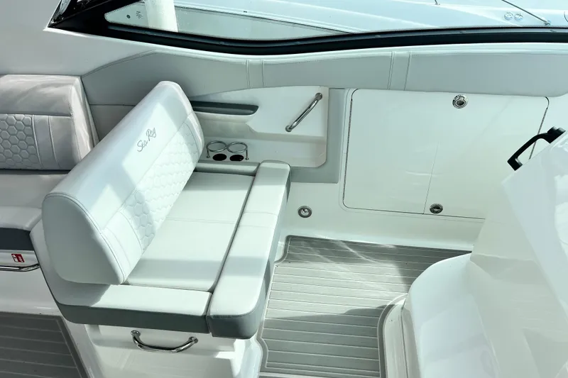 Slide: The Image of 2025 Sea Ray Sundancer 320 Outboard interior with white seating and sleek design. - 13