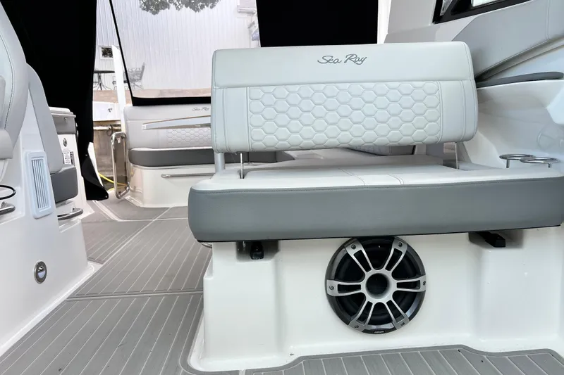 Slide: The Image of 2025 Sea Ray Sundancer 320 Outboard interior with stylish seating and speaker system. - 14