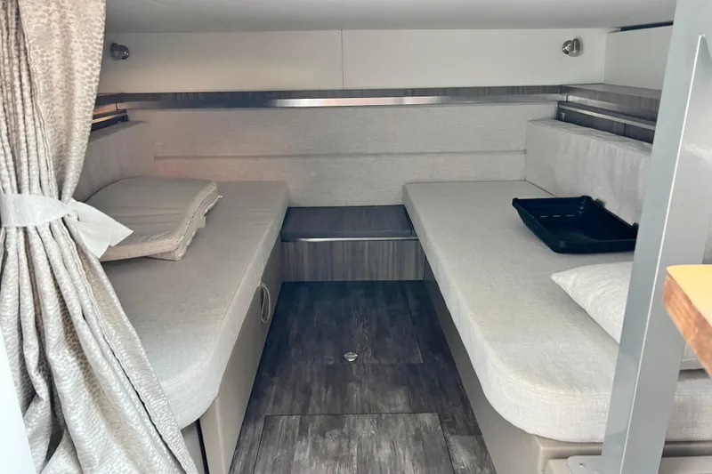 Slide: The Image of 2025 Sea Ray Sundancer 320 Outboard cabin interior with cozy seating and modern design. - 15