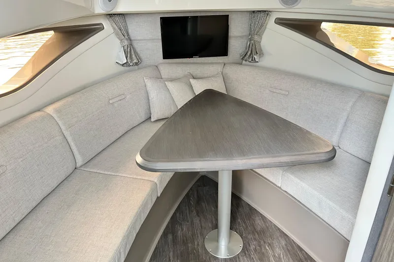 Slide: The Image of 2025 Sea Ray Sundancer 320 Outboard interior with cozy seating and modern table. - 17