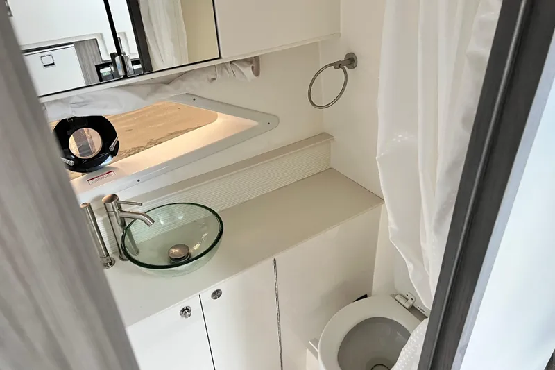 Slide: The Image of 2025 Sea Ray Sundancer 320 Outboard bathroom with modern sink and toilet. - 19